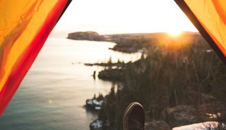 tourist lying in camping tent near shore