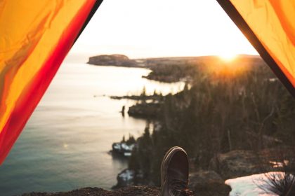 tourist lying in camping tent near shore